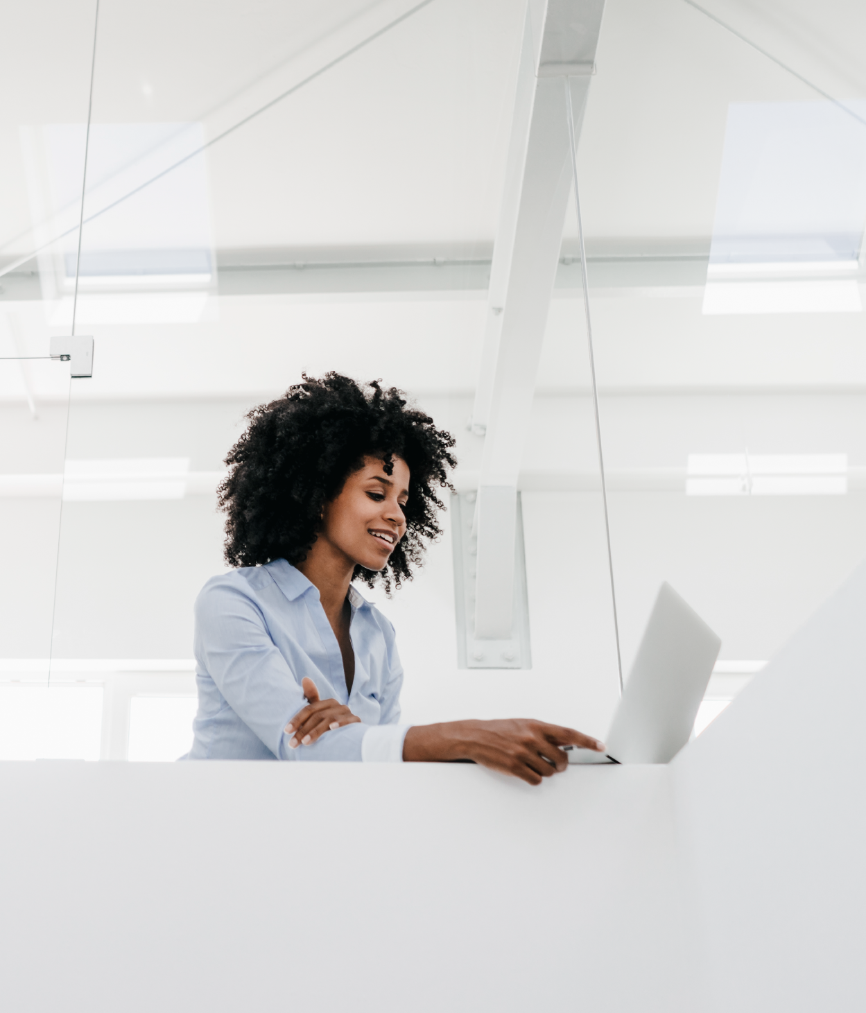 Black businesswoman works on her laptop in an office